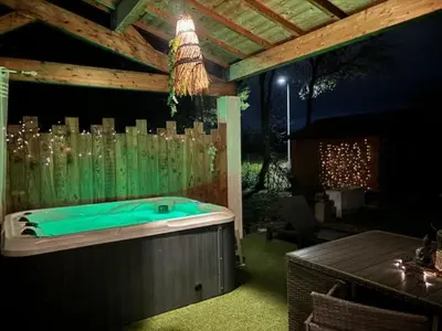 a jacuzzi tub in a backyard at night at La Villa Claudia Jardin et Spa in Pennautier