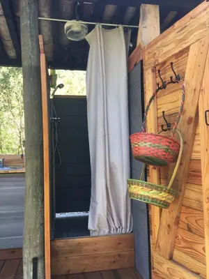 a shower stall with two baskets on the door at Moulin de la Buade in Termes