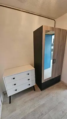 a dressing room with a dresser and a mirror at Studio plage du Grazel in Gruissan