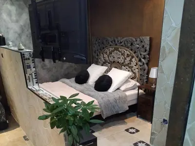 a bedroom with a bed with pillows and a mirror at Drissia&Othman Atipik in Carcassonne