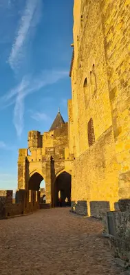 a large stone building with an archway in front of it at Drissia&Othman Atipik in Carcassonne