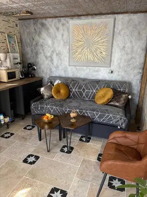 a living room with a couch and a table at Drissia&Othman Atipik in Carcassonne