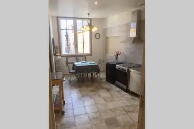 a kitchen with a table and a stove top oven at Appartement Narada à Limoux in Limoux