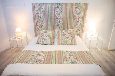 a bedroom with a bed with two pillows on it at Le Gite des Jardins de Mazamet in Mazamet