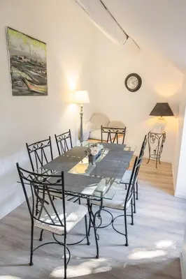 a dining room with a table and chairs at Le Gite des Jardins de Mazamet in Mazamet