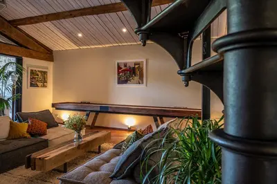 a living room with a couch and a pool table at La Remise Penthouse in Le Somail