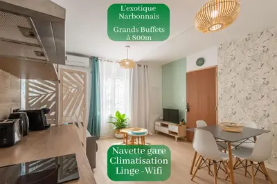 a kitchen with a table and chairs in a room at L'Exotique Narbonnais in Narbonne