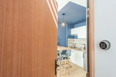 a door leading into a kitchen with a surfboard at Le Cosy Narbonnais in Narbonne