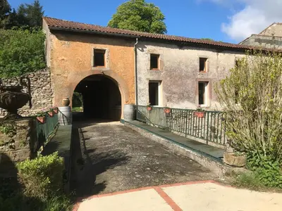 an entrance to a building with a gate at Residence Le petit paradis - La petite maison in Labastide-Rouairoux