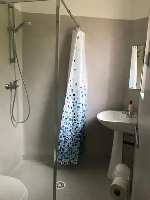 a bathroom with a glass shower with a sink at Residence Le petit paradis - La petite maison in Labastide-Rouairoux
