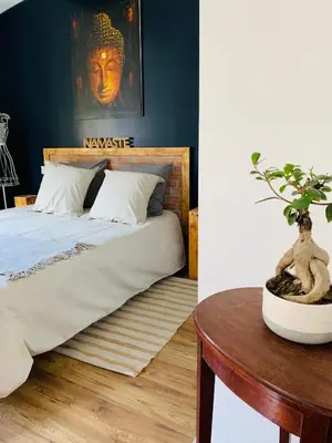 a bedroom with a bed and a table with a plant at L'atypique, La Vue et le Standing du 36 ! Emplacement, clim et extérieur ! in Carcassonne