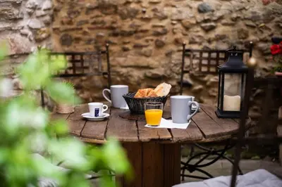 a table with coffee cups and bread and a lantern at L'atypique, La Vue et le Standing du 36 ! Emplacement, clim et extérieur ! in Carcassonne