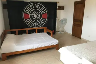 a bedroom with a bed and a black and white sign at Maison spacieuse in Gruissan