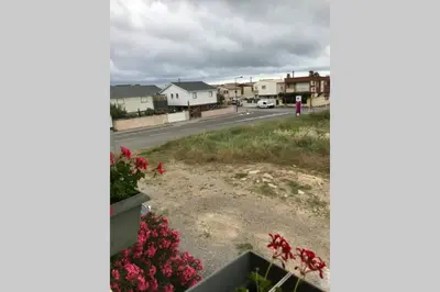 a view from a window of a street with houses at Maison spacieuse in Gruissan