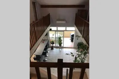 an overhead view of a living room with stairs at Maison spacieuse in Gruissan