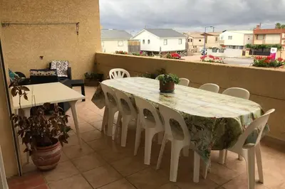 a table and chairs on a balcony with a view at Maison spacieuse in Gruissan