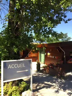 a sign in front of a building at Écolodge Les Sentiers du Lac - Domaine de la Gaïa in Sorèze