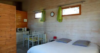 a bedroom with a bed in a wooden wall at Écolodge Les Sentiers du Lac - Domaine de la Gaïa in Sorèze