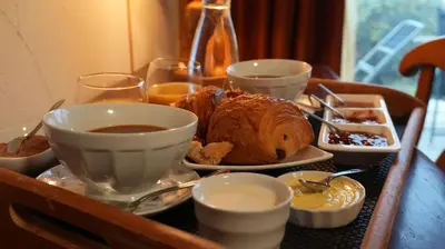 a tray with a table with food and drinks on it at Écolodge Les Sentiers du Lac - Domaine de la Gaïa in Sorèze
