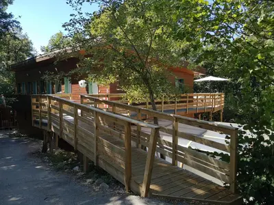 a wooden deck in front of a house at Écolodge Les Sentiers du Lac - Domaine de la Gaïa in Sorèze