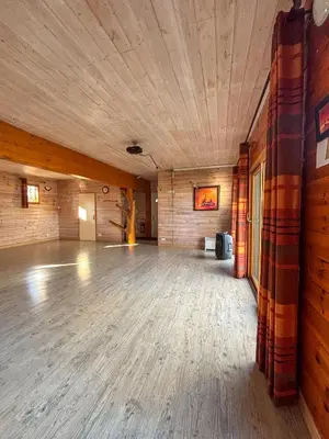 a large room with a wooden floor and a wooden ceiling at Écolodge Les Sentiers du Lac - Domaine de la Gaïa in Sorèze