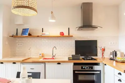 a kitchen with a sink and a stove top oven at gite echarou Chez Nine in Sigean