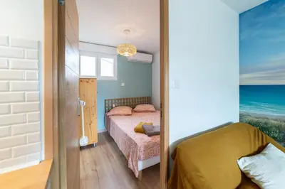 a small bedroom with a bed in a room at gite echarou Chez Nine in Sigean