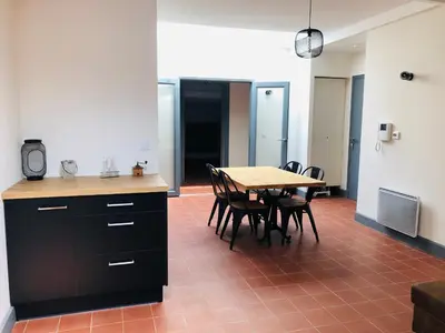 a kitchen and dining room with a table and chairs at DOLCE VITA in Carcassonne