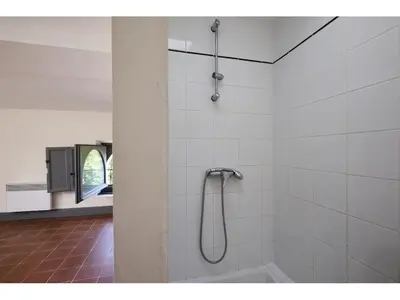 a shower in a bathroom with white tiles at DOLCE VITA in Carcassonne