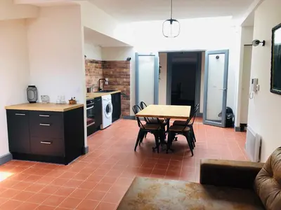 a kitchen and living room with a table and chairs at DOLCE VITA in Carcassonne
