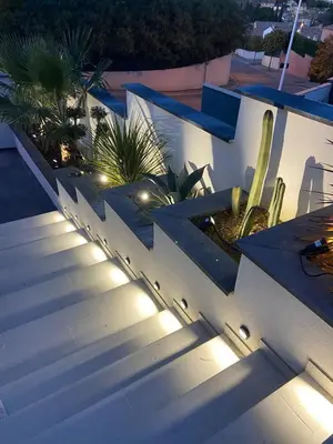 a staircase with lights on the side of a building at Fun and sun room in Salles-d'Aude