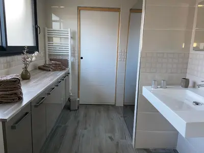 a white bathroom with a sink and a mirror at Fun and sun room in Salles-d'Aude