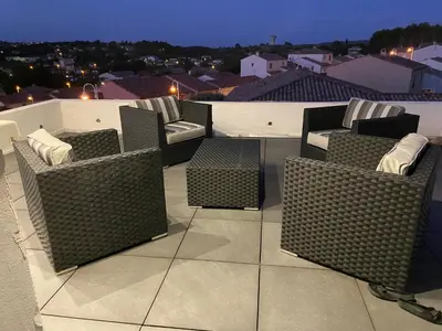 a group of wicker chairs sitting on top of a roof at Fun and sun room in Salles-d'Aude