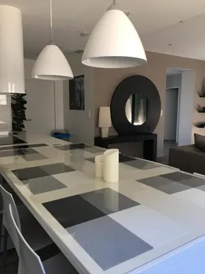 a dining room with a black and white checkered table at Fun and sun room in Salles-d'Aude