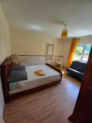 a bedroom with a bed and a large window at Los olivos in Bize-Minervois