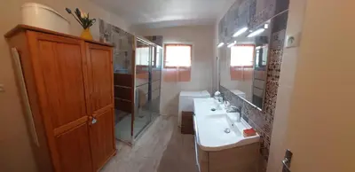 a bathroom with a sink and a toilet and a mirror at Los olivos in Bize-Minervois