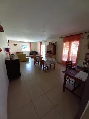a large living room with a table and chairs at Los olivos in Bize-Minervois