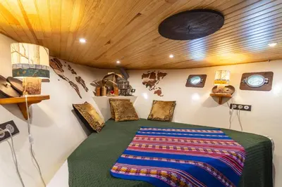 a bedroom in a tiny house with a bed at Bateau Le Nubian in Narbonne
