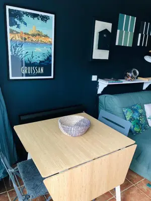 a wooden table with a bowl on top of it at Studio cabine GRUISSAN PLAGE DU GRAZEL in Gruissan