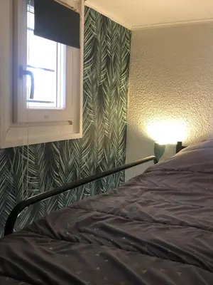 a bedroom with a bed next to a window at Studio cabine GRUISSAN PLAGE DU GRAZEL in Gruissan