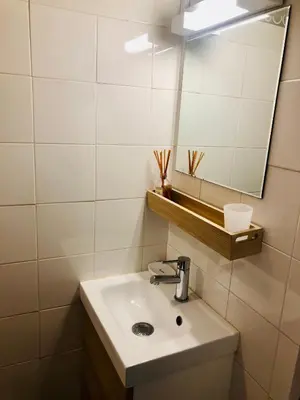 a bathroom with a sink and a mirror at Studio cabine GRUISSAN PLAGE DU GRAZEL in Gruissan