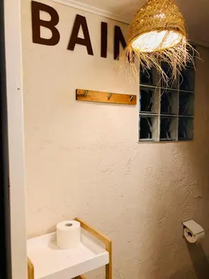 a bathroom with a toilet and a sign on the wall at Studio cabine GRUISSAN PLAGE DU GRAZEL in Gruissan