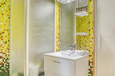 a bathroom with a sink and a mirror at Les Vignes de Carcassonne - Classé 4 étoiles Piscine et clim in Capendu