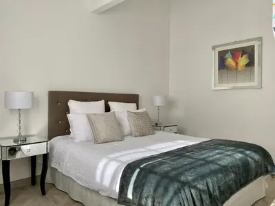 a bedroom with a large bed with white sheets and pillows at Manoir et Appartements avec piscine au Domaine de Bize Mirepoix in Mirepoix
