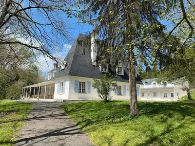 a large white house with a black roof at Manoir et Appartements avec piscine au Domaine de Bize Mirepoix in Mirepoix