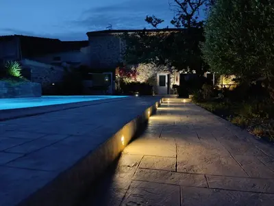 a pathway with lights on the side of a house at Loft au bord du Canal du Midi in Roubia