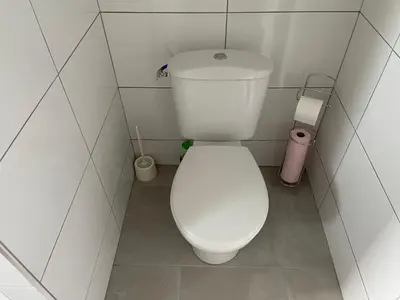 a bathroom with a white toilet in a stall at Maison vivancos in Narbonne