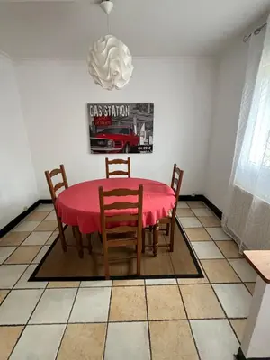 a dining room with a red table and chairs at Maison vivancos in Narbonne