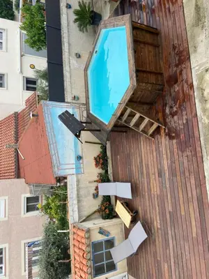 an outdoor swimming pool on the side of a building at Maison vivancos in Narbonne