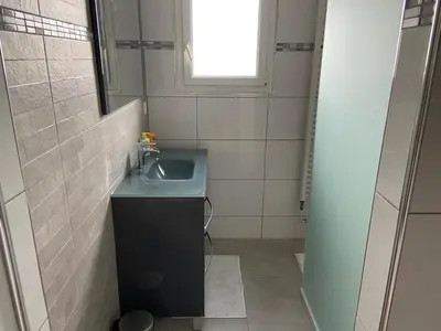 a small bathroom with a sink and a window at Maison vivancos in Narbonne